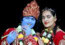 Children dress up as Lord Krishna, painting their faces blue