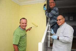 Hendon and Finchley MP Mike Freer with Barnet Councillors Melvin Cohen and Andrew Harper help to paint a hallway and flat at Norwood residential accomodation in Oakfield Road, Finchley Central