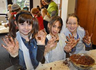 Edgware District Reform Synagogue religion school children help make chocolate cakes for the homeless.
