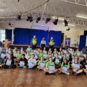 Schoolchildren receive their certificates after completing Hertfordshire Constabulary's Mini-Police scheme