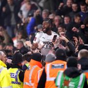 Tyrone Marsh celebrates with the Boreham Wood fans after the momentous 1-0 FA Cup win at Bournemouth. Credit: PA