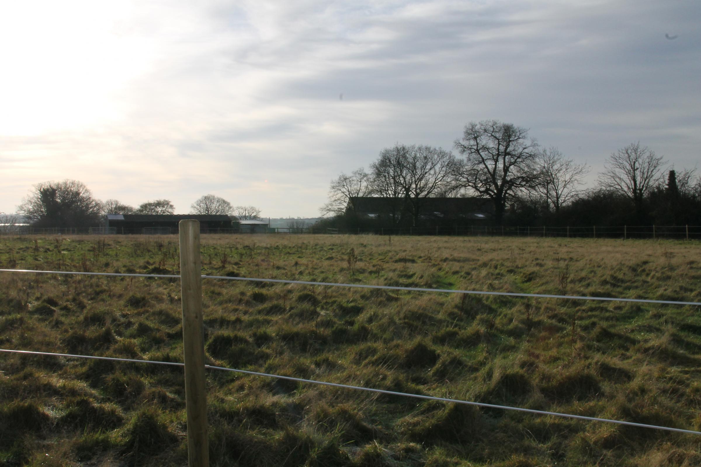 Pictured in the distance to the right are some of the existing stable buildings. Campaigners fear views may be spoilt by gardens. Credit: Sharon Madsen