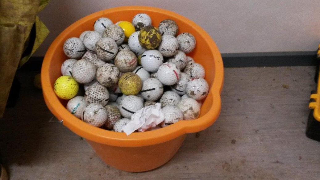 A bucket of golf balls collected on the site of the substation. Credit: UK Power Networks