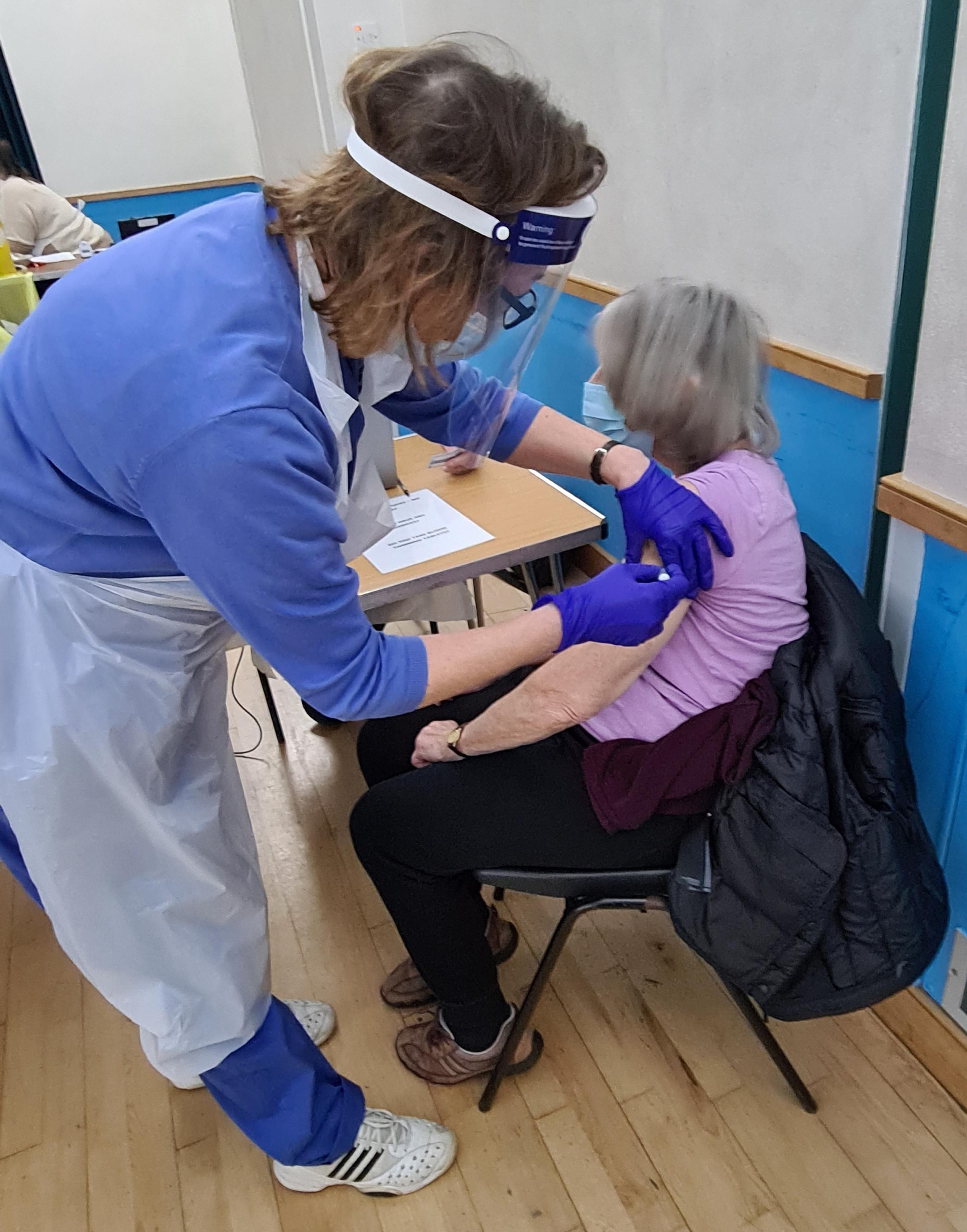Dr Goddard receiving her second jab at around 6.30pm on Wednesday at Allum Hall. Credit: Tony Battison
