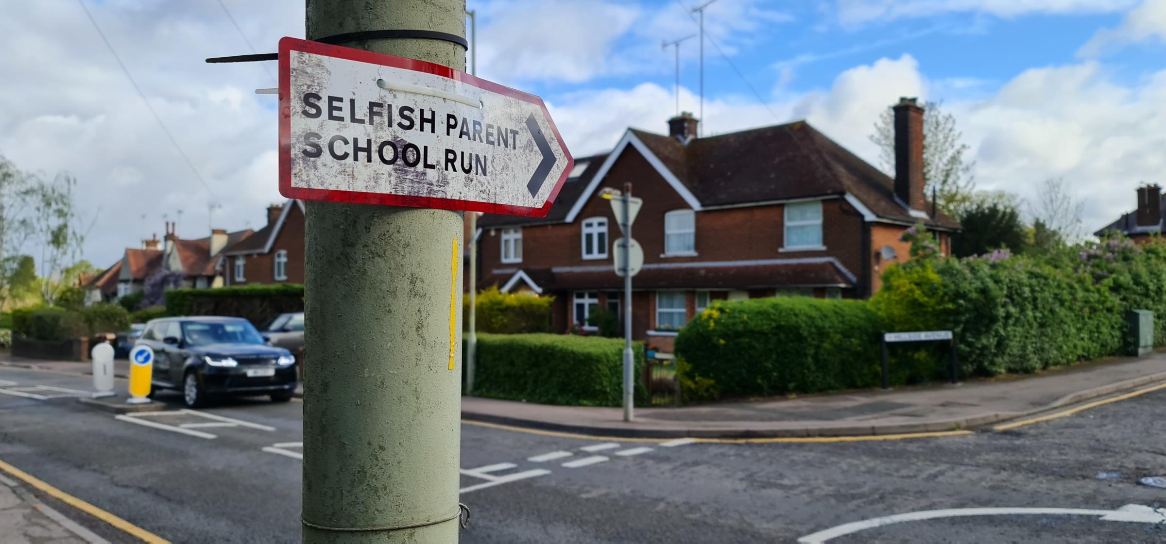 This sign stating Selfish Parent School Run has been stuck to a lamppost pointing in the direction of Hillside Avenue in Borehamwood
