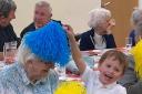 Children play with elderly people at Kingswood Nursery School's Getting Together club