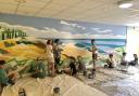 The beach mural being painted at Forest Village Care Home in Borehamwood. Image: Sheara Abrahams