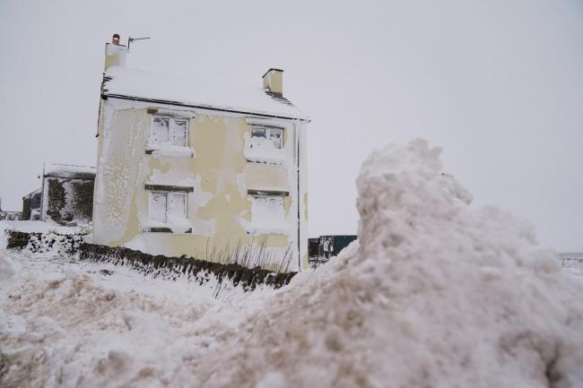 A house covered in snow on the A53 close to Buxton in Derbyshire, amid freezing conditions in the aftermath of Storm Arwen. Picture date: Sunday November 28, 2021.