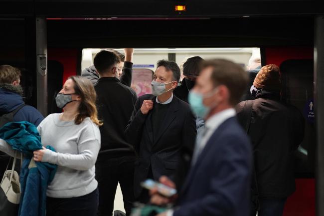 People wearing masks travelling on the London Underground