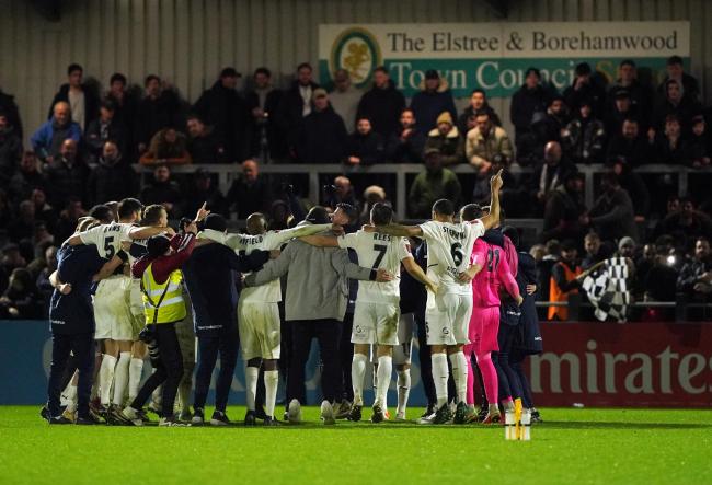 Boreham Wood players celebrate at full time during the Emirates FA Cup third round match at the LV Bet Stadium Meadow Park. Credit: PA