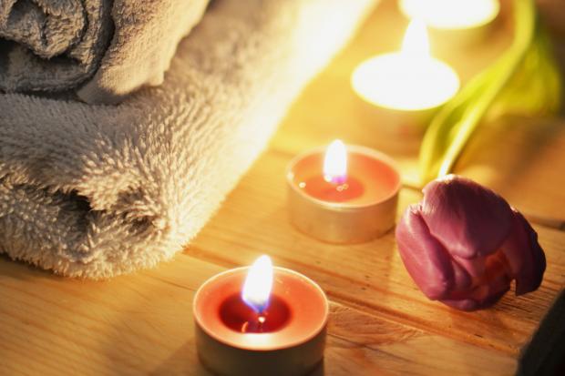 Borehamwood Times: A pile of towels, candles and a tulip. Credit: Canva