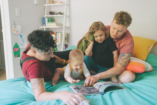 Borehamwood Times: A family reading a book together. Credit: Canva