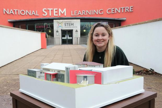 Ella Bennett with her miniature version of the National STEM Learning Centre (NSLC) in York which she created in lockdown for her BA Model Design & Effects course.