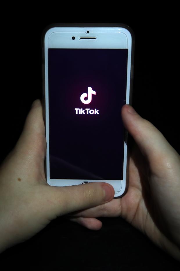 Borehamwood Times: A person with TikTok open on their phone. Credit: PA