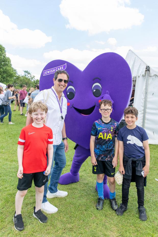 Borehamwood Times: Jewish Care chief executive Daniel Carmel-Brown with Jewish Care's mascots and young attendees. Credit: Justin Grainge