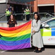Photo outside Hertsmere Civic Offices shows from left to right Sergeant Noel Buckley, Executive Director Peter Geraghty, Cllr Rebecca Challice and Cllr Meenal Sachdev with the Pride Progress flag and Hertfordshire Constabulary's Pride-liveried