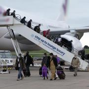 Afghans leave a chartered civilian flight which landed in the UK from Kabul. Credit: Ministry of Defence/PA