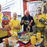 Rotarians help collect food at Tescos last week