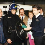 Teamwork: Pauline Poole, second from right, and the Neighbourhood Watch group at a riot reconstruction with Metropolitan Police in 1994